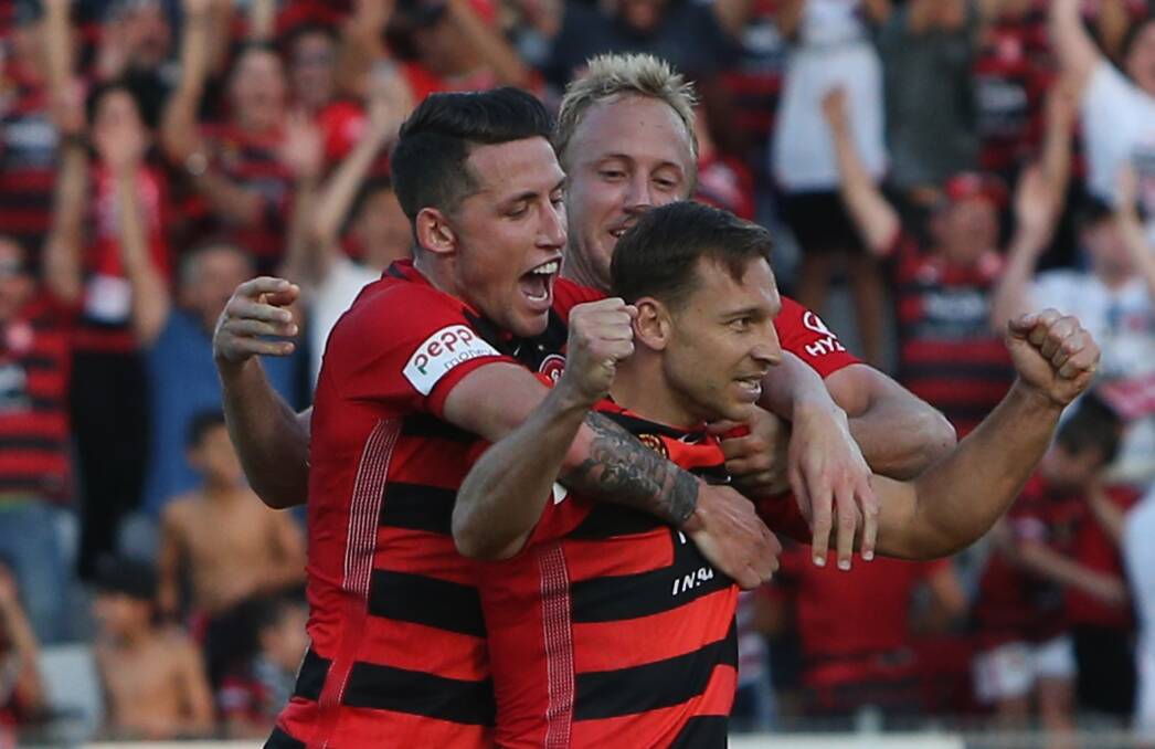 Way to go: Brendon Santalab, Mitch Nichols and Scott Neville celebrate a Wanderers goal against the Central Coast Mariners at the weekend. Picture: Getty Images