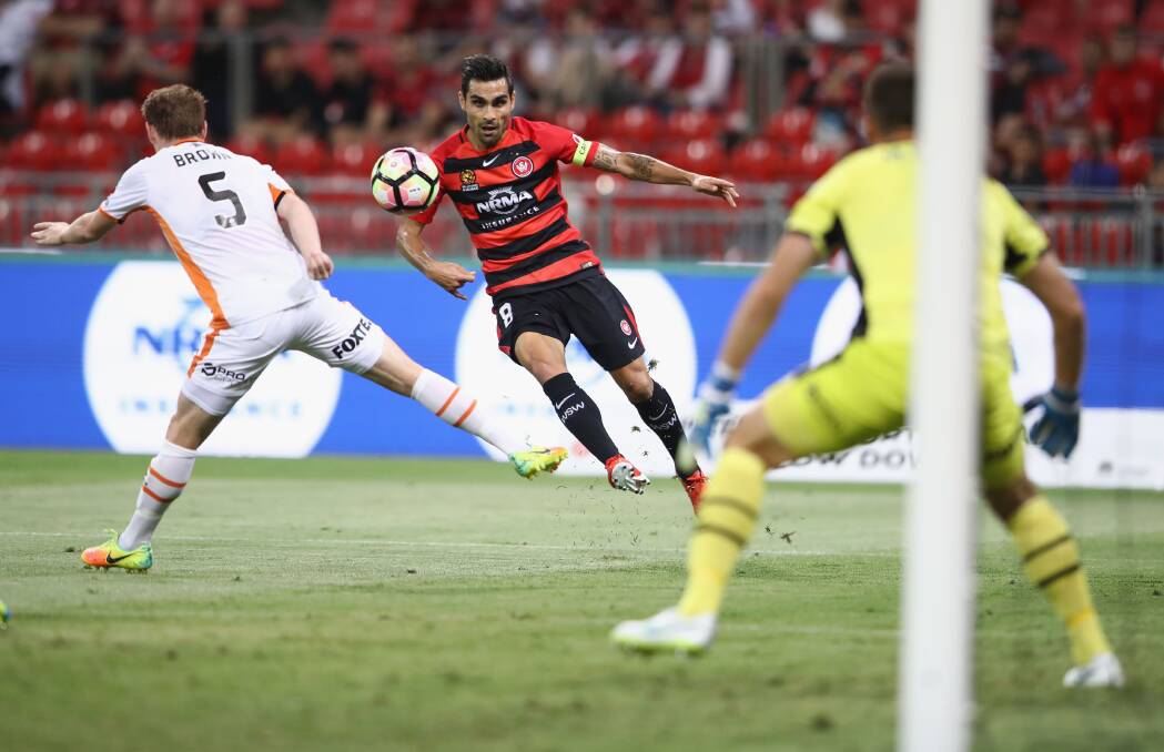 SHOOTS: Dimas Delgado takes a shot at the Brisbane Roar goal while being pressured by Corey Brown at the weekend. Picture: Getty Images