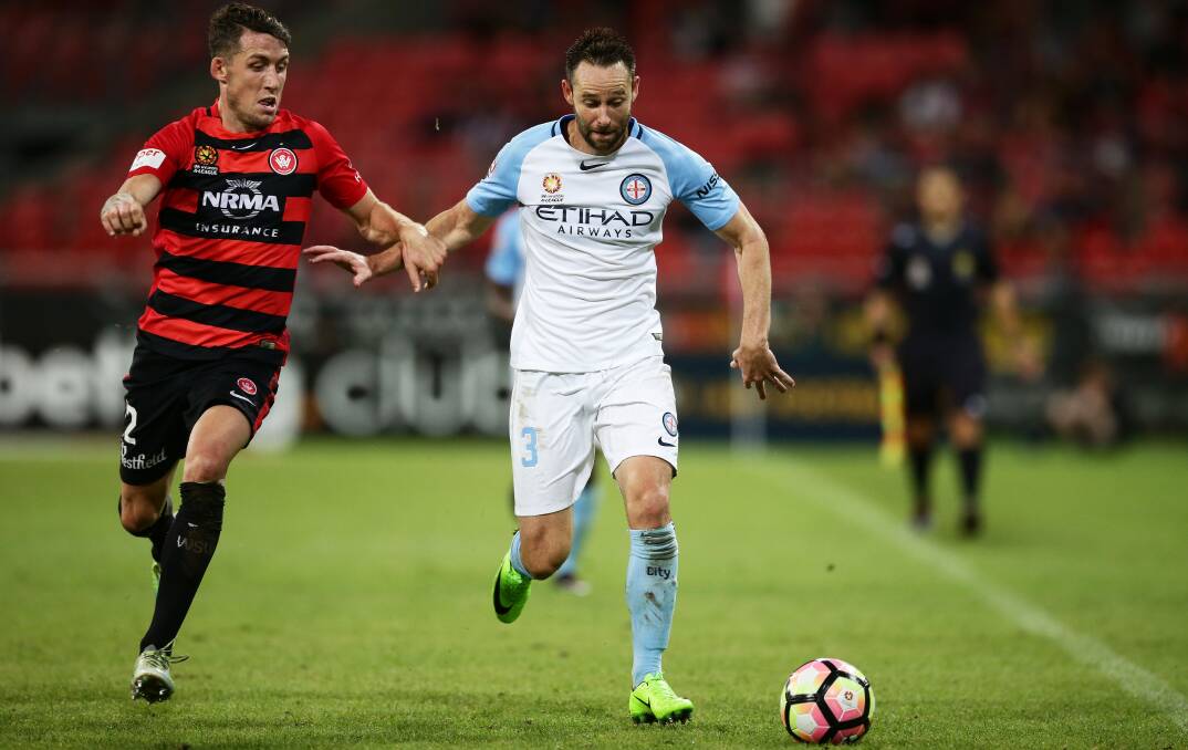 IT'S MINE: Scott Neville challenges Melbourne City's Josh Rose for the ball during the Wanderers' big win over City. Picture: Getty Images
