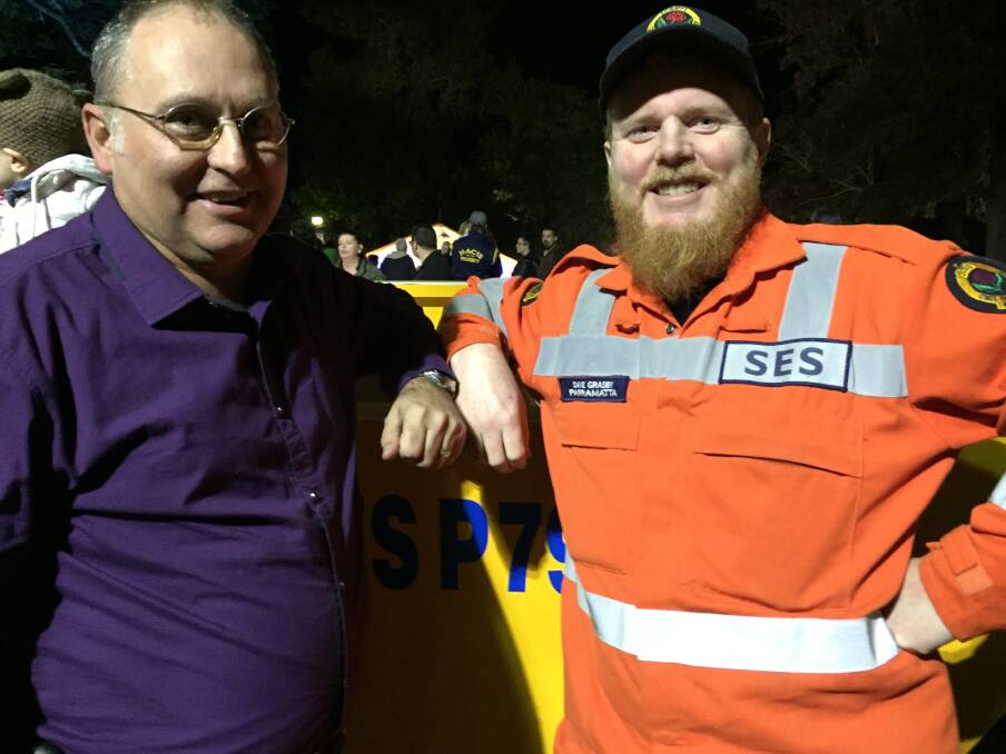 Freemans Reach resident Maurice Geake and SES's Dave Grasby prop up the SES flood boat. 