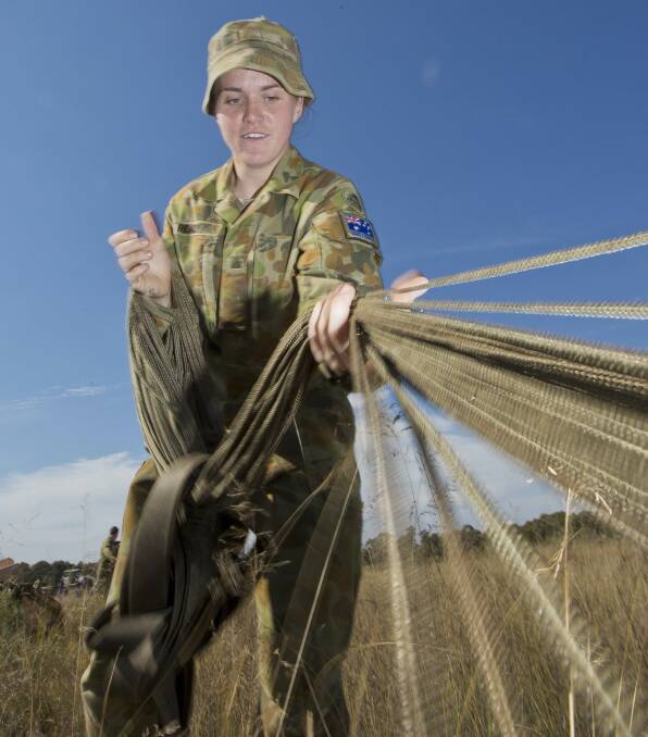 Private Maddison Ready from 176 Air Dispatch Squadron repacks a parachute.