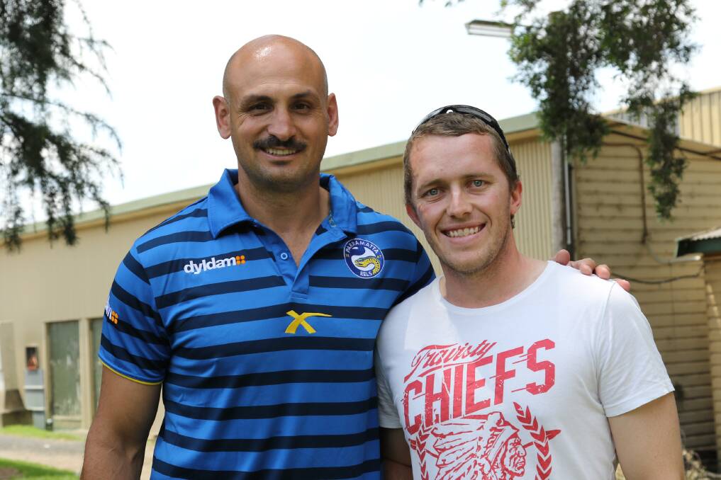 PUMPED: Parramatta Eels player and ambassador Michael Vella and Penrith PE teacher Michael Beggs at Sunday's International Food Fair and CPR day. Mr Beggs won the CPR endurance challenge and Mr Vella came second. Picture: Alan Sadleir
