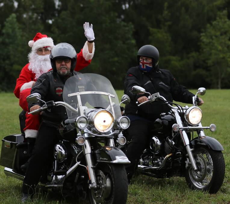 Santa's escort meant business in getting the big man to his big gig.