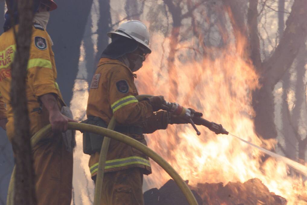 Grose Vale Rural Fire Brigade members put out a fire at Kurrajong Heights. Picture: Andrew Taylor
