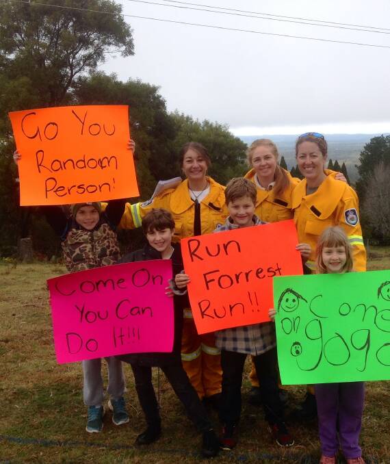 Barrackers cheer runners on in 2014 with placards such as 'Go you Random Person'. 