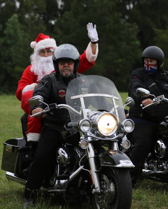 Santa is escorted to the festivities after arriving by helicopter.