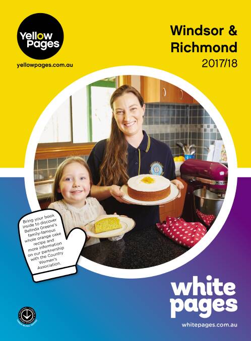 Belinda Greene of Colo Heights and daughter Chelsea with the fabulous whole orange cake on the front of our new phone book.