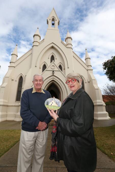 Reverend David Kidd with Councillor Christine Paine and the plaster plaque of the church she found at fair 15 years ago. Do you have any memorabilia from the church you can share? Picture: Geoff Jones