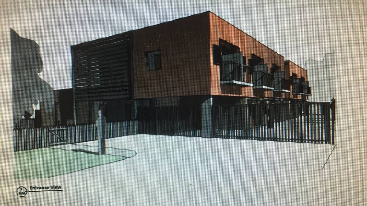 The boarding house proposed for March Street, Richmond. The front face is the darker face to the left. A gated driveway runs down the side. 