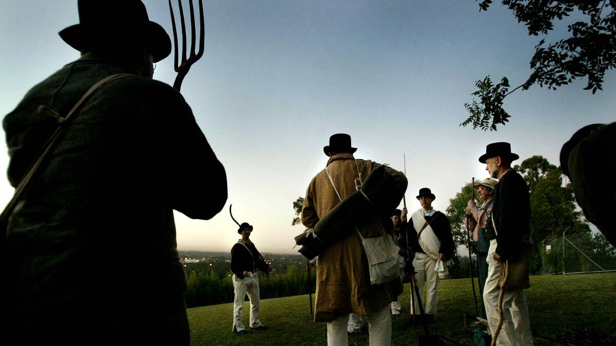 Actors wait in the dawn light for the signal to march in a Battle of Vinegar Hill re-enactment in 2015.