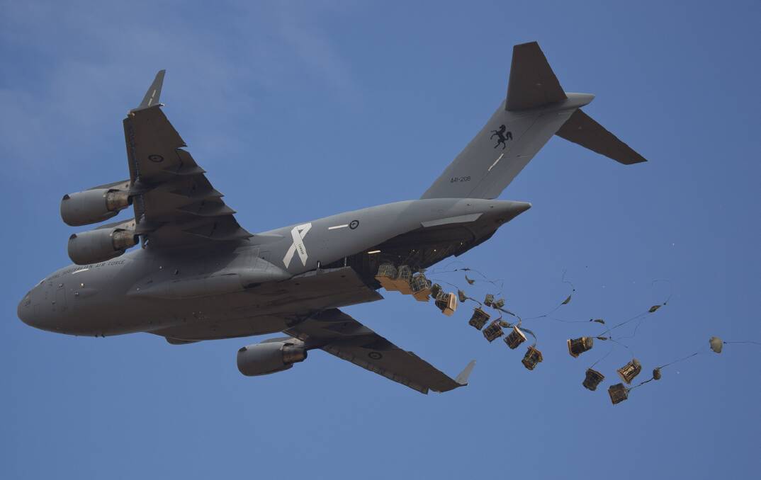 A C-17A Globemaster deploys the load over the Londonderry Drop Zone.