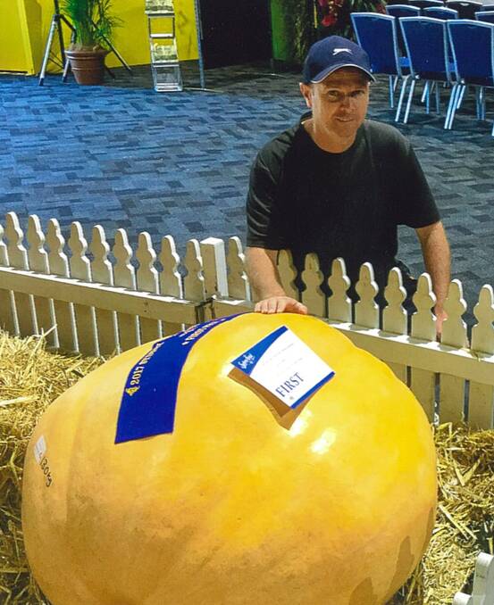 Paul Simmons of South Windsor with his first-prize-winning giant pumpkin at Sydney Royal, which netted him $1000.