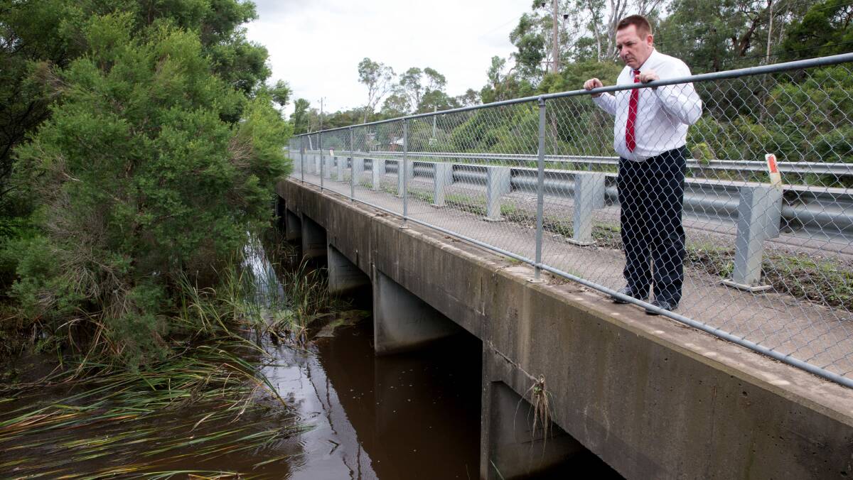Penrith Councillor Marcus Cornish at the flood easement under Londonderry Road which he said needs cleaning out to increase its capacity. Picture: Geoff Jones