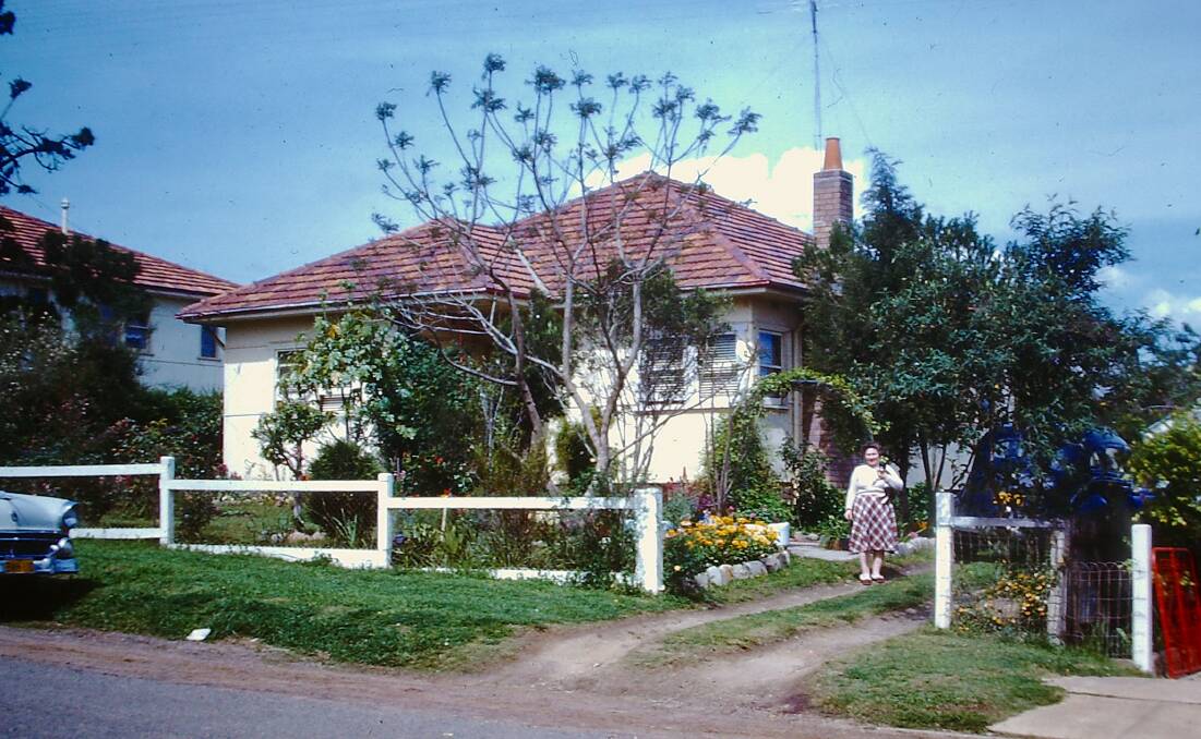 FIBRO DREAM HOME: The author's childhood home at 44 Court Street, Windsor around 1960. Her mother Iris Cammack is in the driveway. The house now has a brick facade. Picture: Bert Hornery