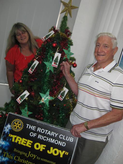 Gazette receptionist Ann De Lanty and Richmond Rotary's Barry Adams with the Tree of Joy.