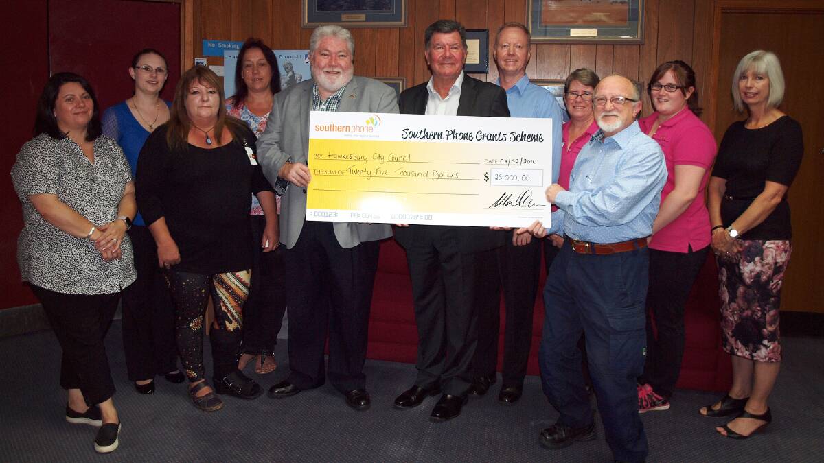  Mayor Kim Ford and Southern Phone managing director, Mark Warren, present Hawkesbury community groups with their share of the $25,000 grant.