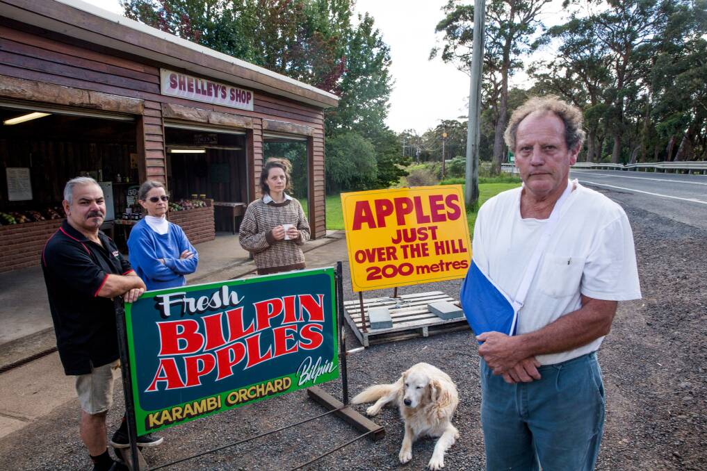 Sam Ramaci from the Cottage which sells apple pies, Shelley and Matilda Julian, Banjo and Neville Julian with two of their three signs. Picture: Geoff Jones