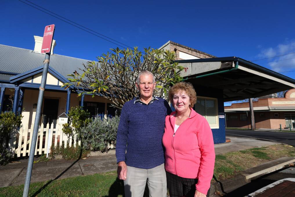 David Reid and wife Helen in front of the house and shop he grew up in on March Street, Richmond. The attached shop is on the corner of Paget Street. Picture: Geoff Jones