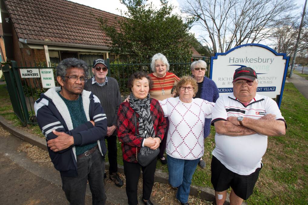 Some of Norman Court's residents: Abeyan Rajadurai, Graeme Bradford, Young Ja Nah, Colleen Scanlon, May, Norma and Trevor Vigar outside the complex in March Street, Richmond. Picture: Geoff Jones