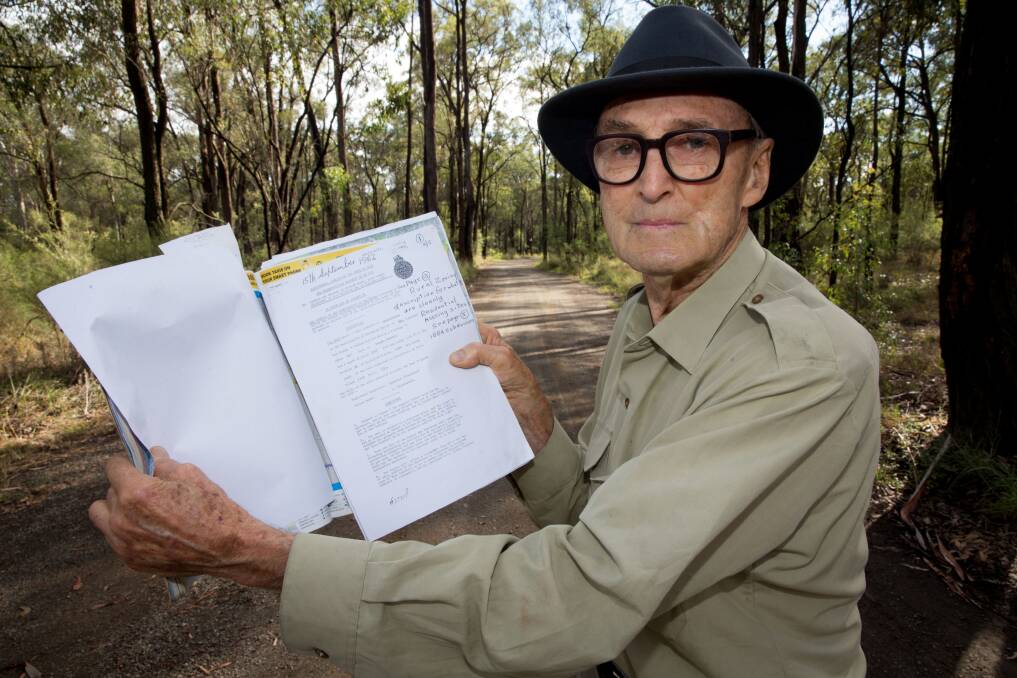 Landowner Jim Cassidy at the site of the four quarter-acre blocks he bought 54 years ago, with the letter confirming his purchase. He is still waiting for infrastructure to come to the area to allow it to be sold. Picture: Geoff Jones