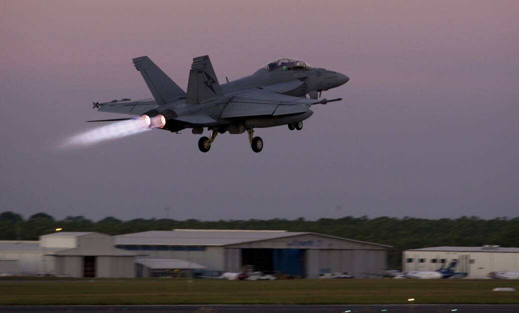 A Hornet takes off for a night training mission.
