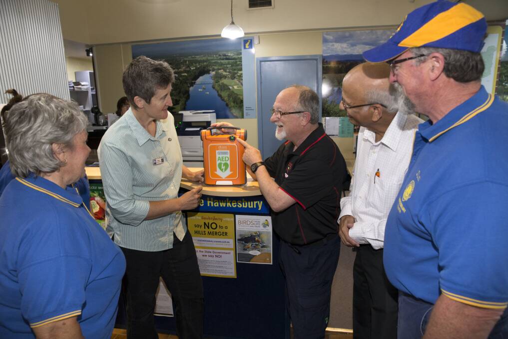 Hawkesbury Tourism Information co-ordinator Mary Harris discusses the new defibrillator with Hawkesbury Heartstart's Peter Gooley at the tourism information centre at Clarendon. Hawkesbury South Lions members Jim and Robyn Rogers (front) and Natalie Wells (obscured) with Hawkesbury Heartstart's Dr Ravi. Picture: Geoff Jones