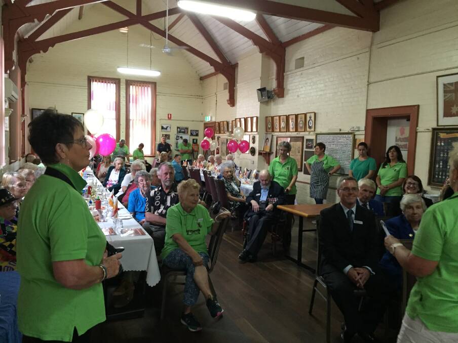 Walers RSL Day Club volunteers in green, and club members, listen to Jann Dewsnap introduce the guest speakers at Wednesday's launch of the hall's new kitchen. 