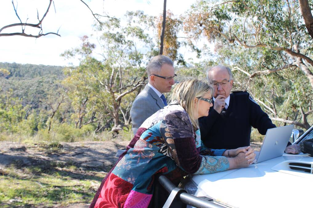 Major projects and local government minister Paul Fletcher, Macquarie MP Louise Markus and deputy captain of the Mt Wilson-Mt Irvine Rural Fire Brigade, Barry Freeman look at the evacuation options for the isolated communities.