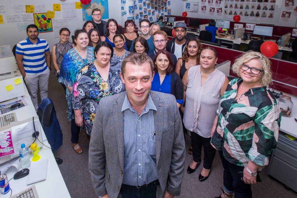 SERVICE: James Caulfield, manager of Classifieds and Contact Centres with Australian Community Media, surrounded by his hardworking Bella Vista-based Classifieds team. Picture: Geoff Jones