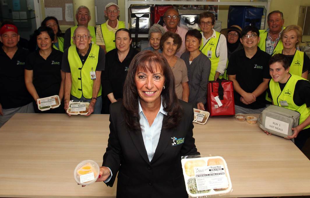  Local achiever: Winner of the 2017 Oatley Woman of the Year award, Nahed Soliman with volunteers in the kitchen of St George Meals on Wheels in the basement of Peakhurst Bowling Club. Picture: Chris Lane