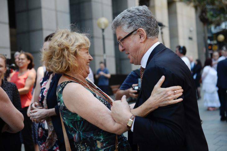Joan Issacs hugs David Marr Witnesses from the Royal Commission into child abuse speak to media outside the commission. Photo: Nick Moir
