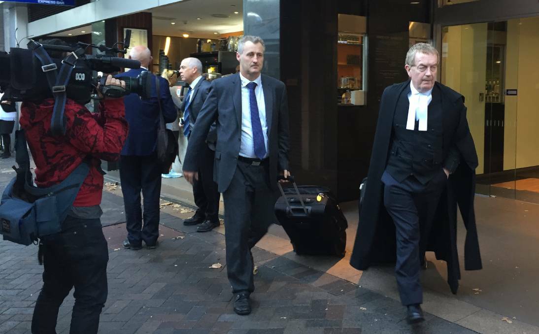 IN COURT: EPA's legal representatives Eric Bateman and barrister Stephen Rushton SC exit the Land and Environment Court.

