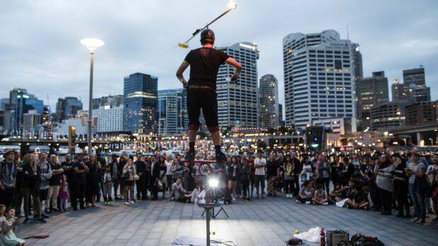Daniel Nimmo performs his circus stunt show in front of a crowd in Darling Harbour. Photo: Dominic Lorrimer