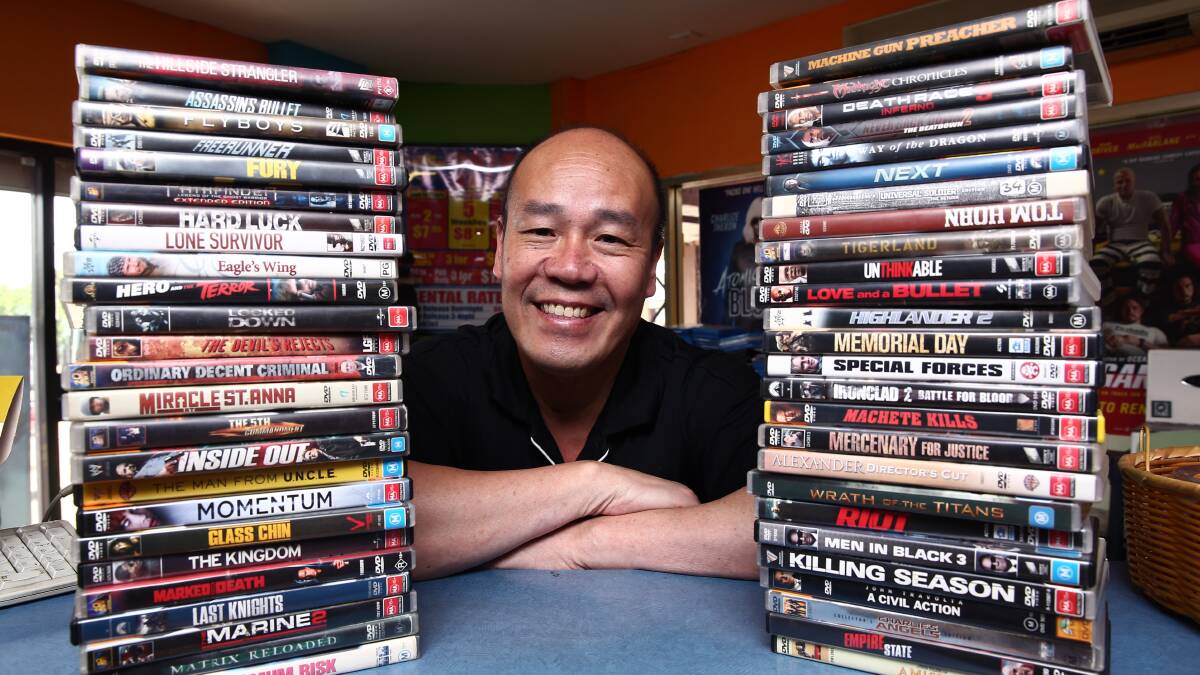 STILL GOING STRONG: Guirong Wu at his Civic Video Windsor store, which is now one of only three video shops left in Greater Sydney. Picture: Geoff Jones