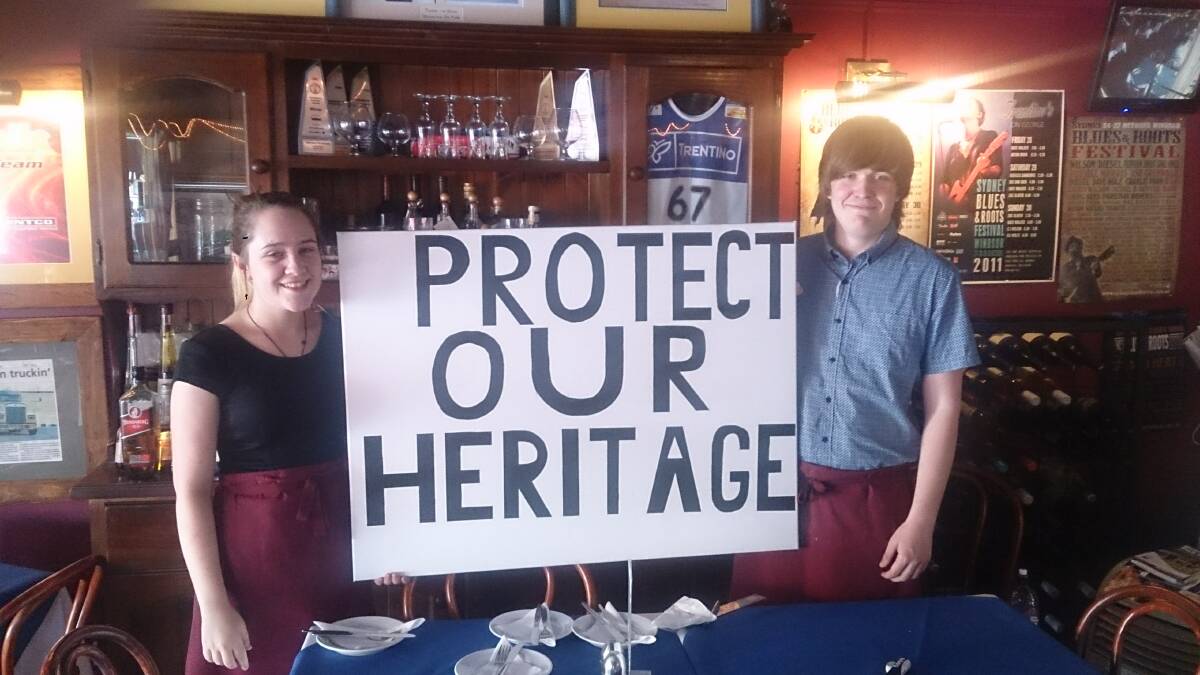 PREPARED: Bianca and Brandon Kelly of Trentino's on George in Windsor holding a placard they plan to take to the proposed council amalgamation rally in Windsor tomorrow. Picture: Supplied