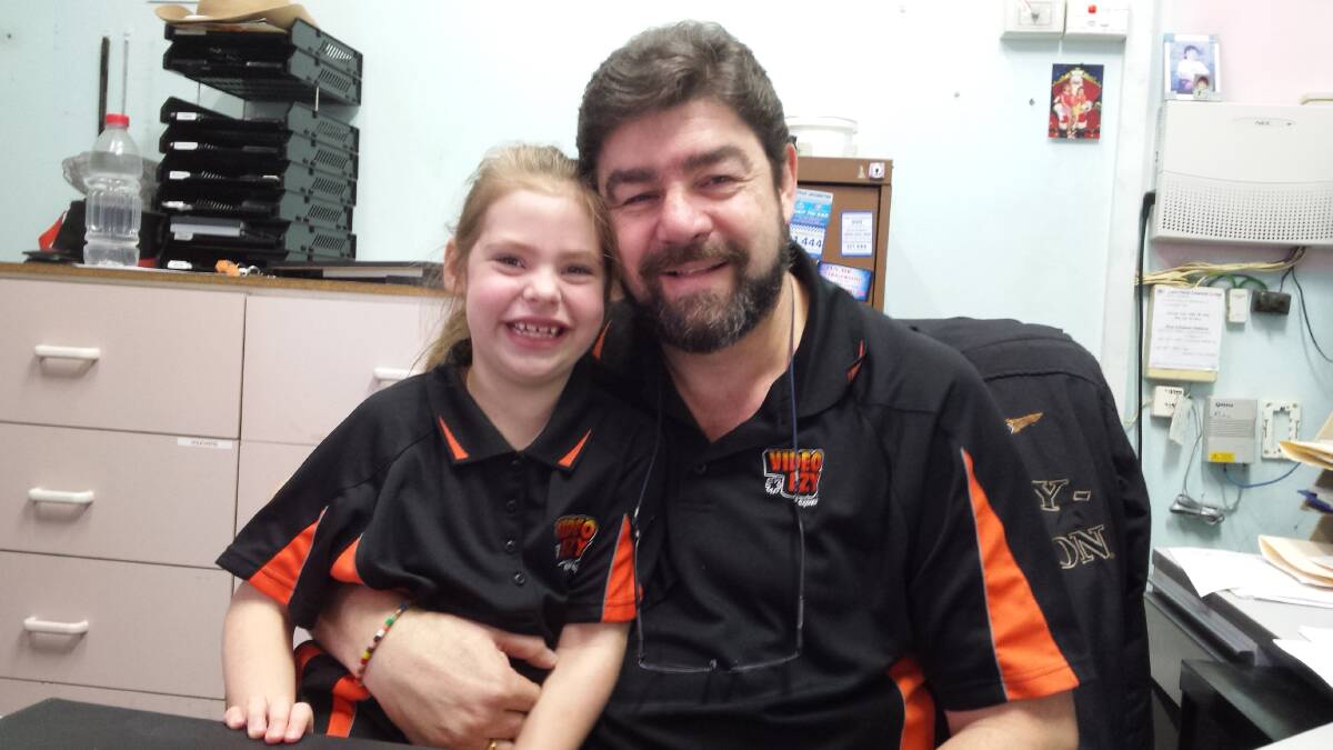 FAMILY: Anika Chadevski (6) and her dad, Steve. She wanted to work at the shop when she got older, but a day spent helping-out while wearing her very own teeny staff t-shirt had to suffice. Picture: Sarah Falson