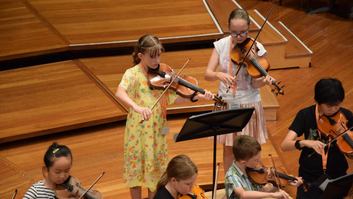 Arabella (yellow dress) during her week at Sydney Youth Orchestra (SYO) Summer School. Picture: Alex Siegers, SYO