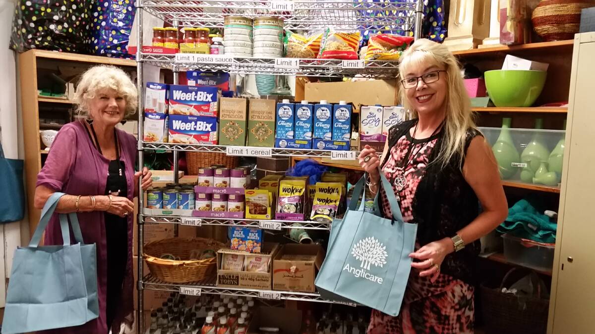 HAND-UP: Volunteer Barbro Watt and store manager Bronwyn Ashcroft showing the bags that can be filled for $10 at Anglicare Richmond's Community Pantry. Picture: Sarah Falson