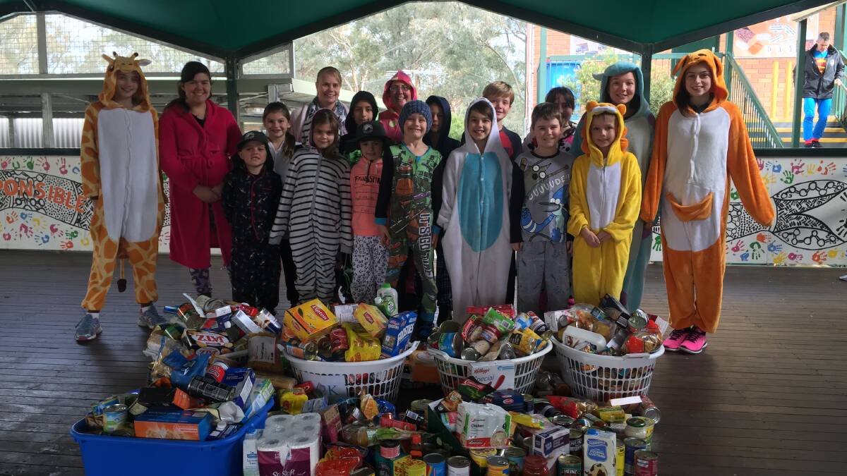 GIVING BACK:  The school's Semester 1 SRC students with all the items donated for charity. 