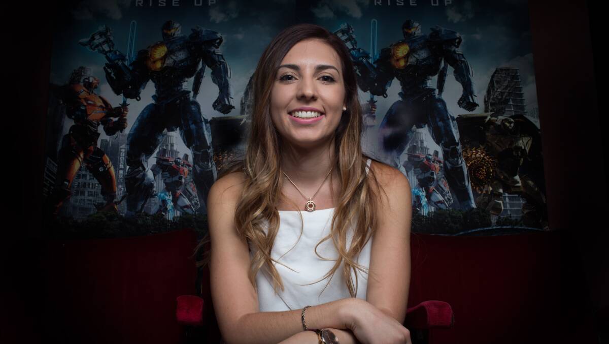 Jasmine Newton at Richmond Regent Twin Cinema. In the background, movie posters promote the film she worked on as visual effects co-ordinator, Pacific Rim Uprising. Picture: Geoff Jones