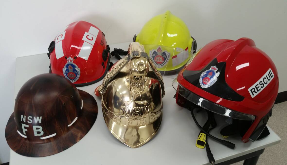100 YEARS OF HEADGEAR: Back row: current multi-purpose helmet (red), and structural helmet phased-out around 15 years ago (yellow). Front row: old multi-purpose helmet (brown), old brass structural helmet (gold), and current structural helmet (red). Picture: Sarah Falson