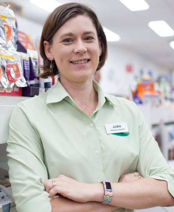 By day: Jodie is one of the friendly faces at the Oz-E Pharmacy in the heart of Richmond. Picture: Geoff Jones