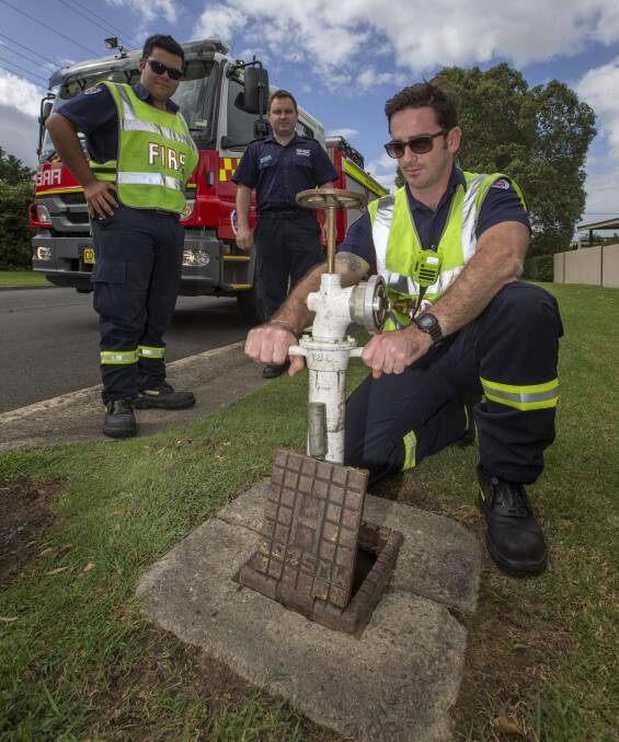 CLEARWAY: Richmond firefighters Carlos Rogas (left) and James Woodberry with station captain James Rowland (centre) in Pitt St, Richmond. Picture: Geoff Jones .
