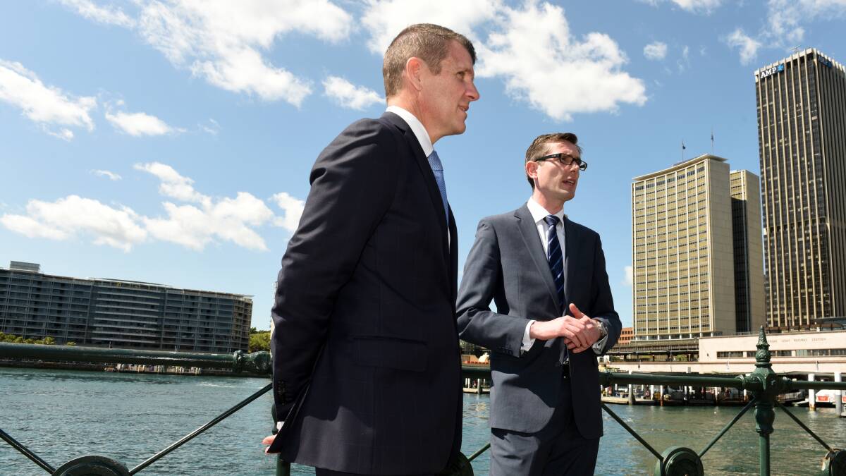 Mike Baird and Dominic Perrottet in Circular Quay in 2015. Mr Perrottet said he was disappointed to hear Mr Baird had resigned after seeing how much dedication he brought to the job. Photo: Steven Siewert
