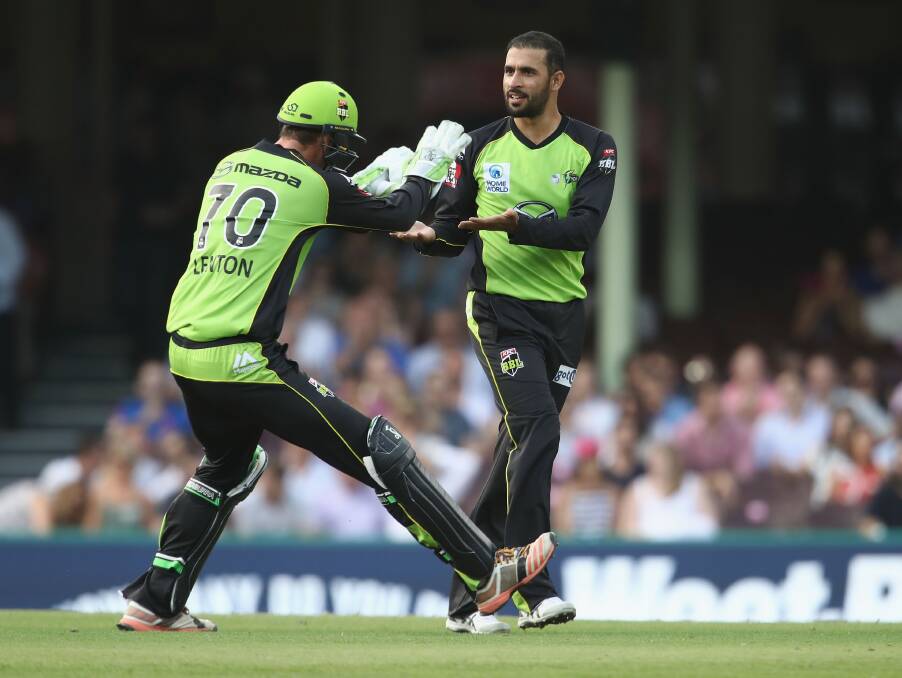 Jay Lenton and Fawad Ahmed celebrate taking the wicket of Sydney Sixers batsman Nic Maddinson of the Sixers during the Big Bash League derby at the Sydney Cricket Ground on Saturday. Picture: Getty Images