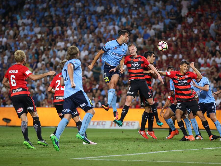 Sydney FC's Bobo leaps above the Western Sydney Wanderers players and headers the ball during the Sydney derby 0-0 draw on Saturday night. Picture: Getty Images