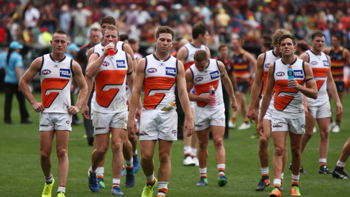 TOUGH LOSS: Dejected GWS Giants players leave the Adelaide Oval after a loss on a very hot South Australian afternoon. Picture: Getty Images