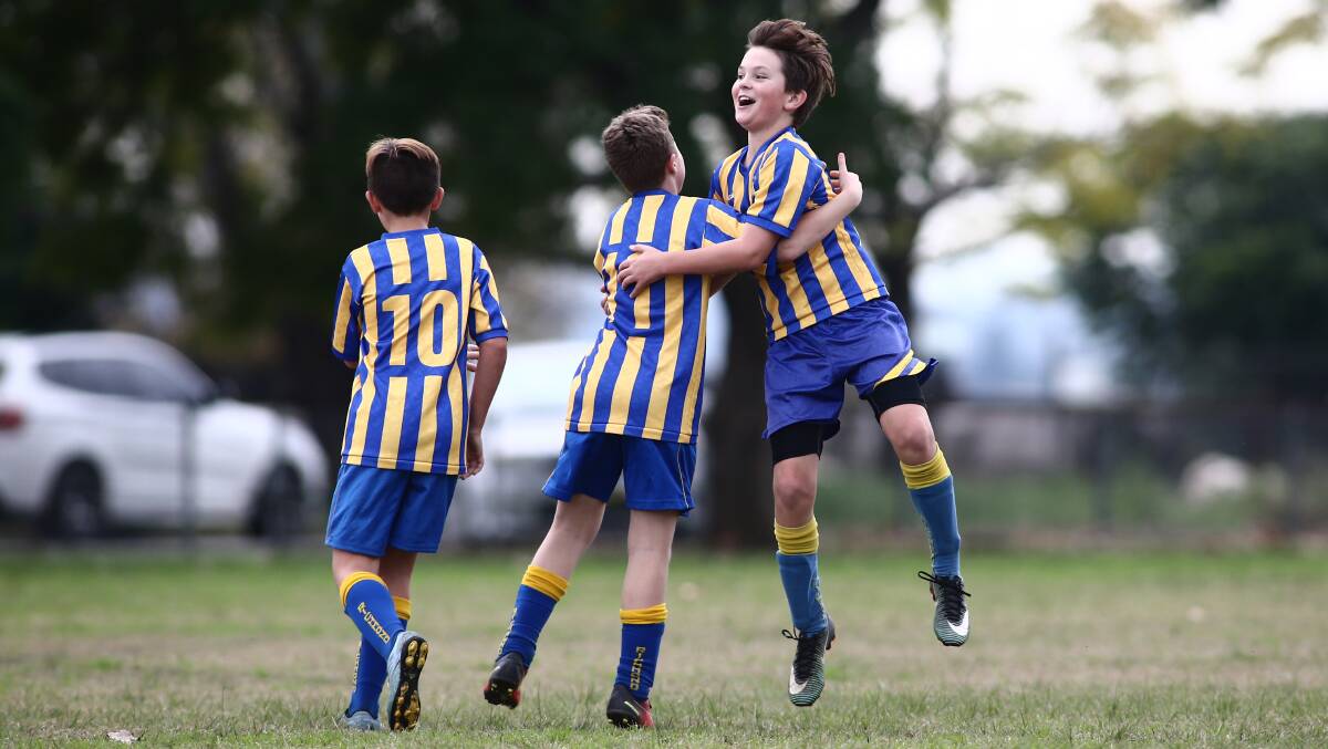 Richmond Ex-Servicemens Soccer Club players celebrate scoring a goal. Many parents will be celebrating the NSW government's Active Kids Rebate. Picture: Geoff Jones