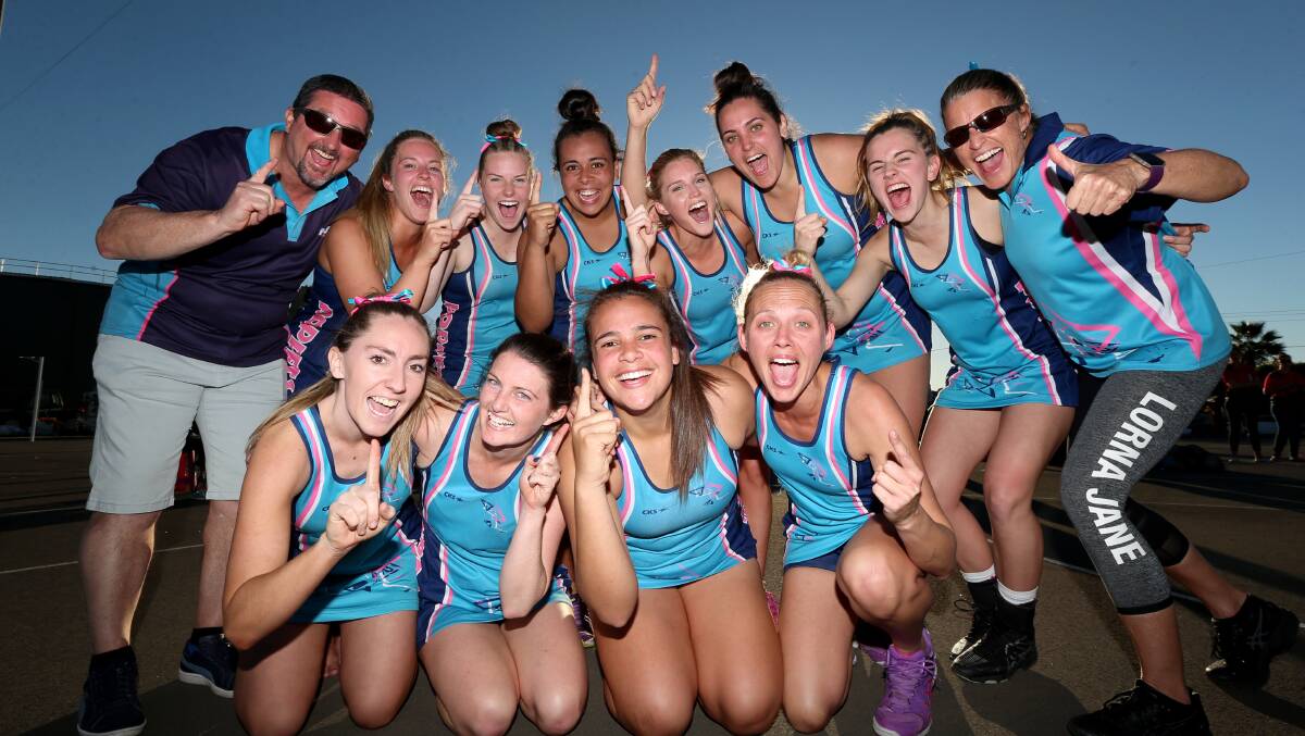 ELATED: Poppets Netball Club players celebrate their 53-43 grand final victory over Macquarie on Saturday afternoon. Picture: Geoff Jones