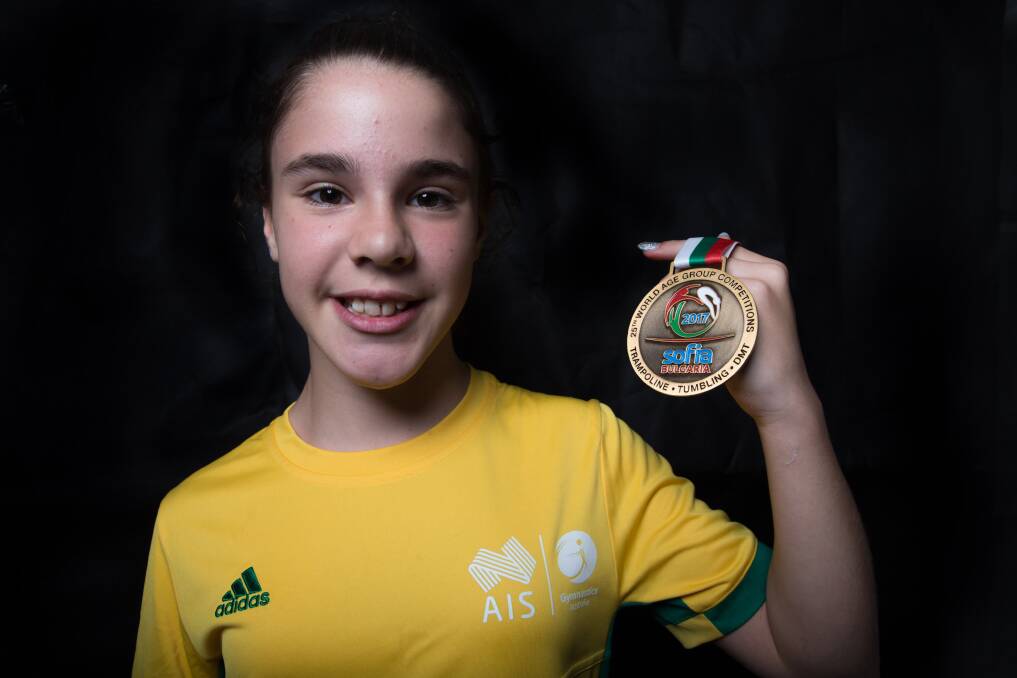 North Richmond tumbler Molly Mamo displays her gold medal, which she won at the 2017 FIG Trampoline Gymnastics World Age Group Competition. Picture: Geoff Jones